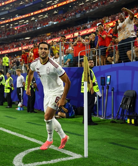 Merino circles the corner flag after securing victory for Spain. Photograph: Kai Pfaffenbach/Reuters
